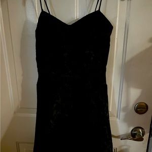 Black dress spaghetti strap with small satin bow at waist.